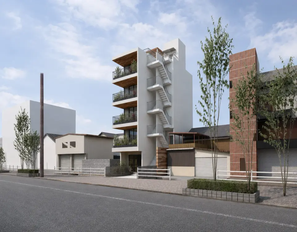 IBARAKI GREEN BLDGの街路からの完成予想CG。周辺の建物の間に立つ、外階段と各階の緑が特徴のビル
